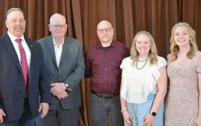 Five adults in formal clothing.