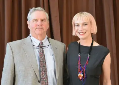 A man and a woman in formal clothing.