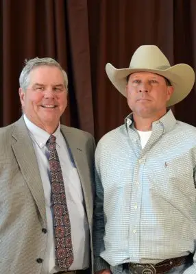 Two men. The right is wearing a cowboy hat.
