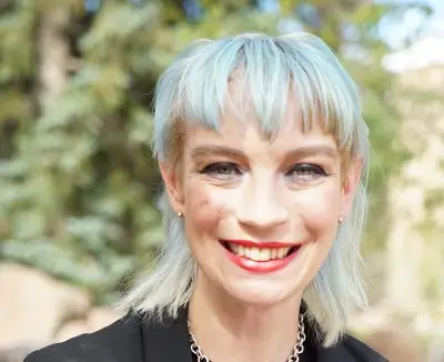 A woman with pale blue hair.
