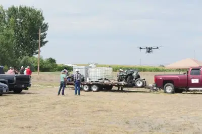 People watch a drone.