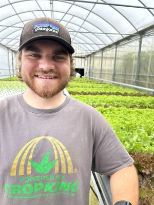 A young man in a greenhouse