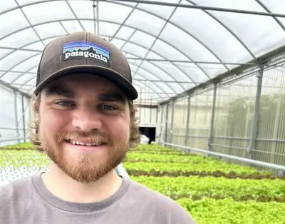A young man in a greenhouse