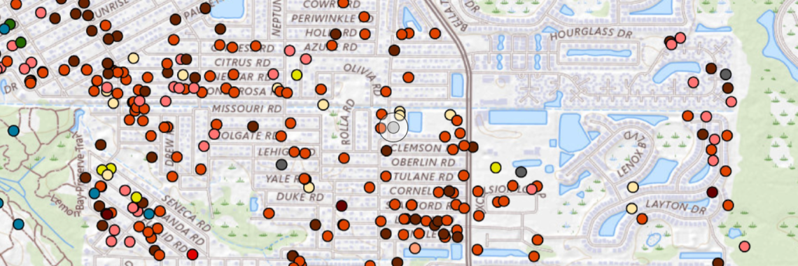 map showing colorful dots, mostly red, yellow, and brownish-red, showing points of damage on streets and residential properties
