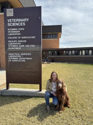 A person with a large dog by UW's Veterinary Sciences building.