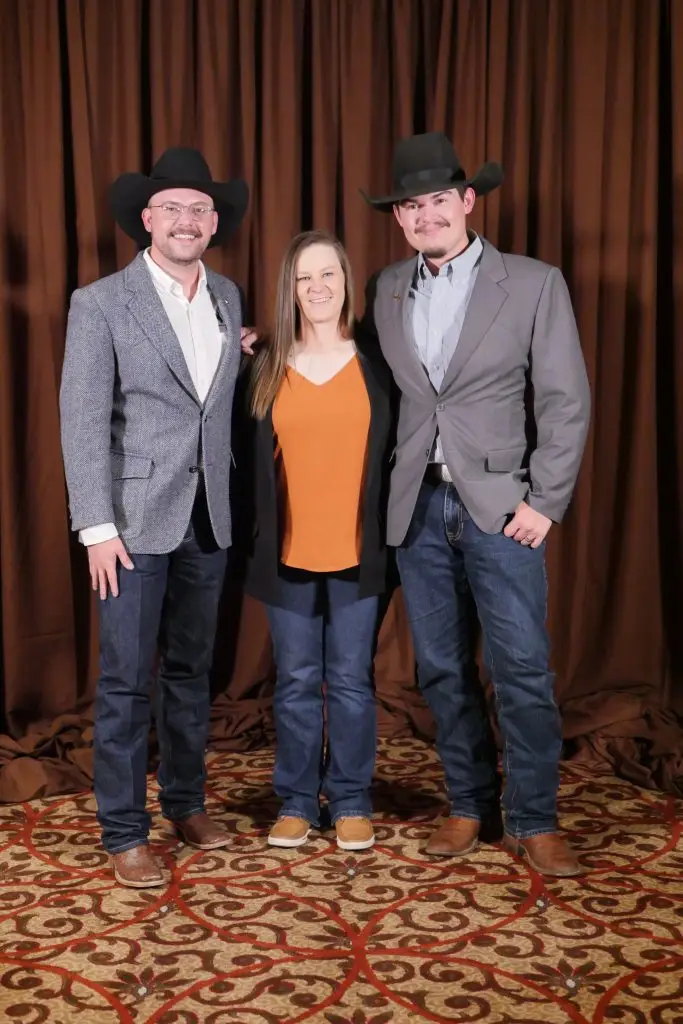 Three people in formal clothing.