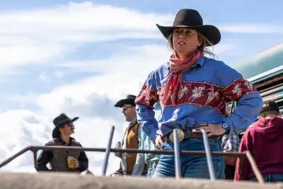Faith Hamlin, dressed in western attire, stands outside.