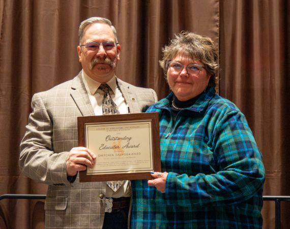 Gretchen Gasvoda-Kelso receives the Outstanding Educator Award from Dean Kelly Crane.
