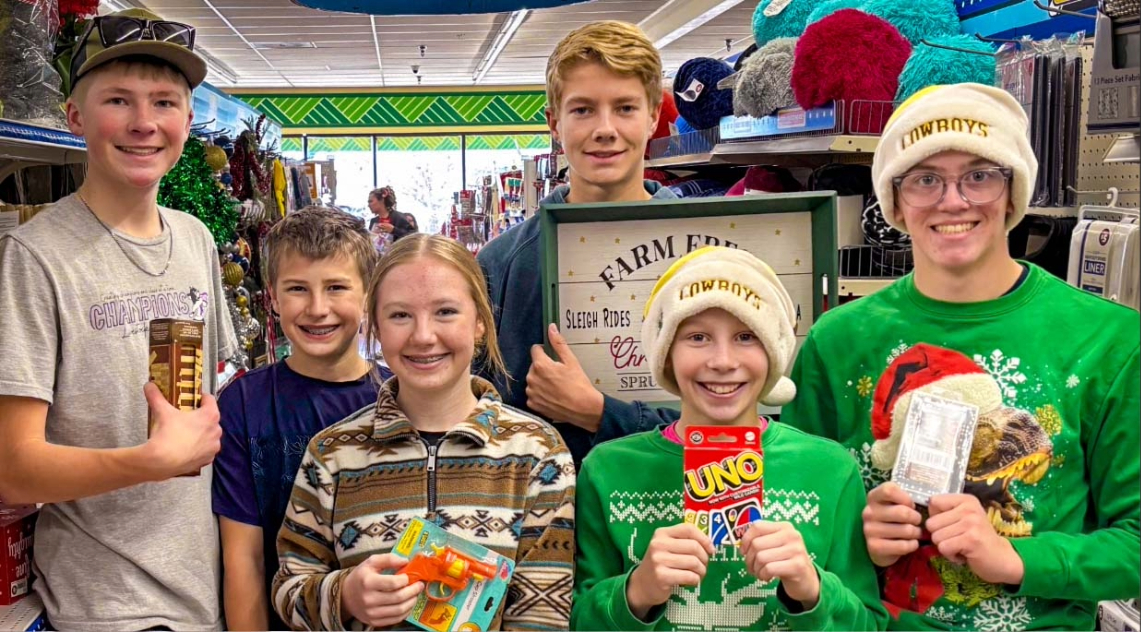 From left to right, Harmony Hustler members Caden Miller, Connor Kimzey, Taylor Kimzey, Landon Olson, Kaleb Strain, and Wyatt Strain shop for a family during their annual Adopt-a-Family community service event. Photo by Jessica Kimzey.