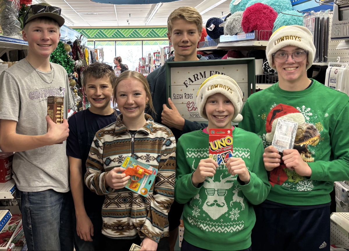 From left to right, Harmony Hustler members Caden Miller, Connor Kimzey, Taylor Kimzey, Landon Olson, Kaleb Strain, and Wyatt Strain shop for a family during their annual Adopt-a-Family community service event. Photo by Jessica Kimzey.