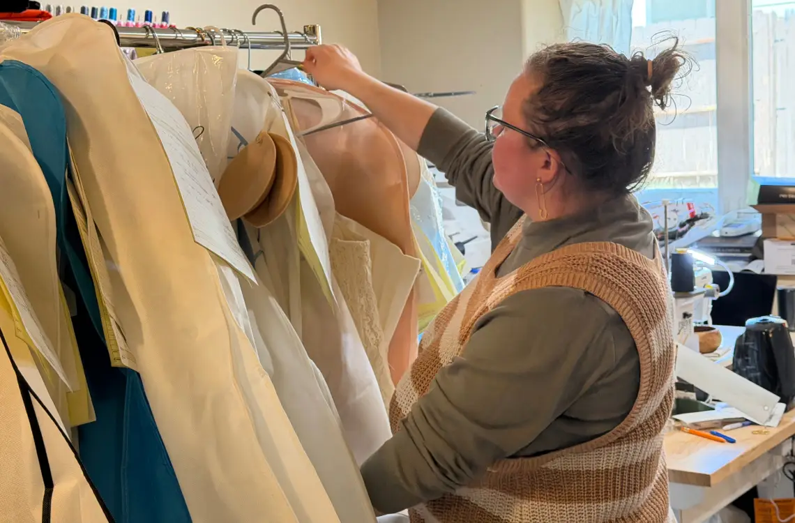 Lauren Carlson in her sewing studio. She specializes in alterations of bridal and formal wear and has begun teaching sewing classes in her community as well. Photo by Caleb Carlson.