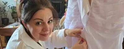UW alumna Oksana Aycock, of Riverton, Wyo., performs alterations on a client’s wedding dress. She is the proprietor of two small businesses, Sunflower Alterations LLC and Sunflower Bride. Photo courtesy of Oksana Aycock.
