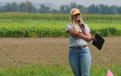 A woman points at a field.