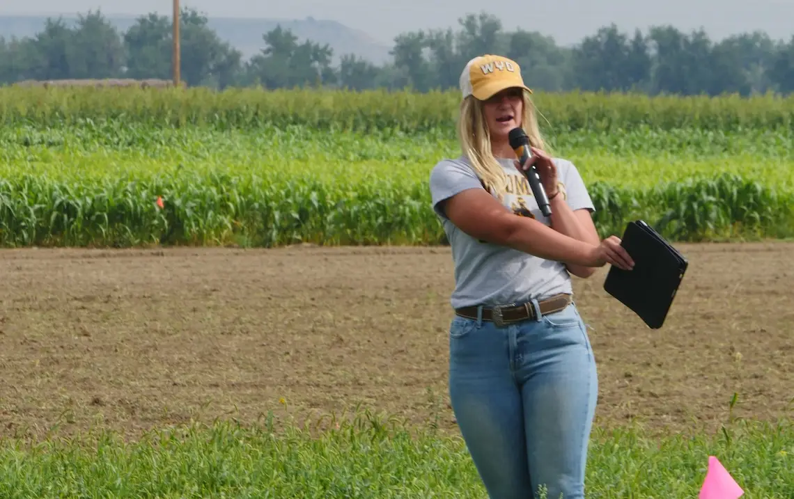 A woman points at a field.