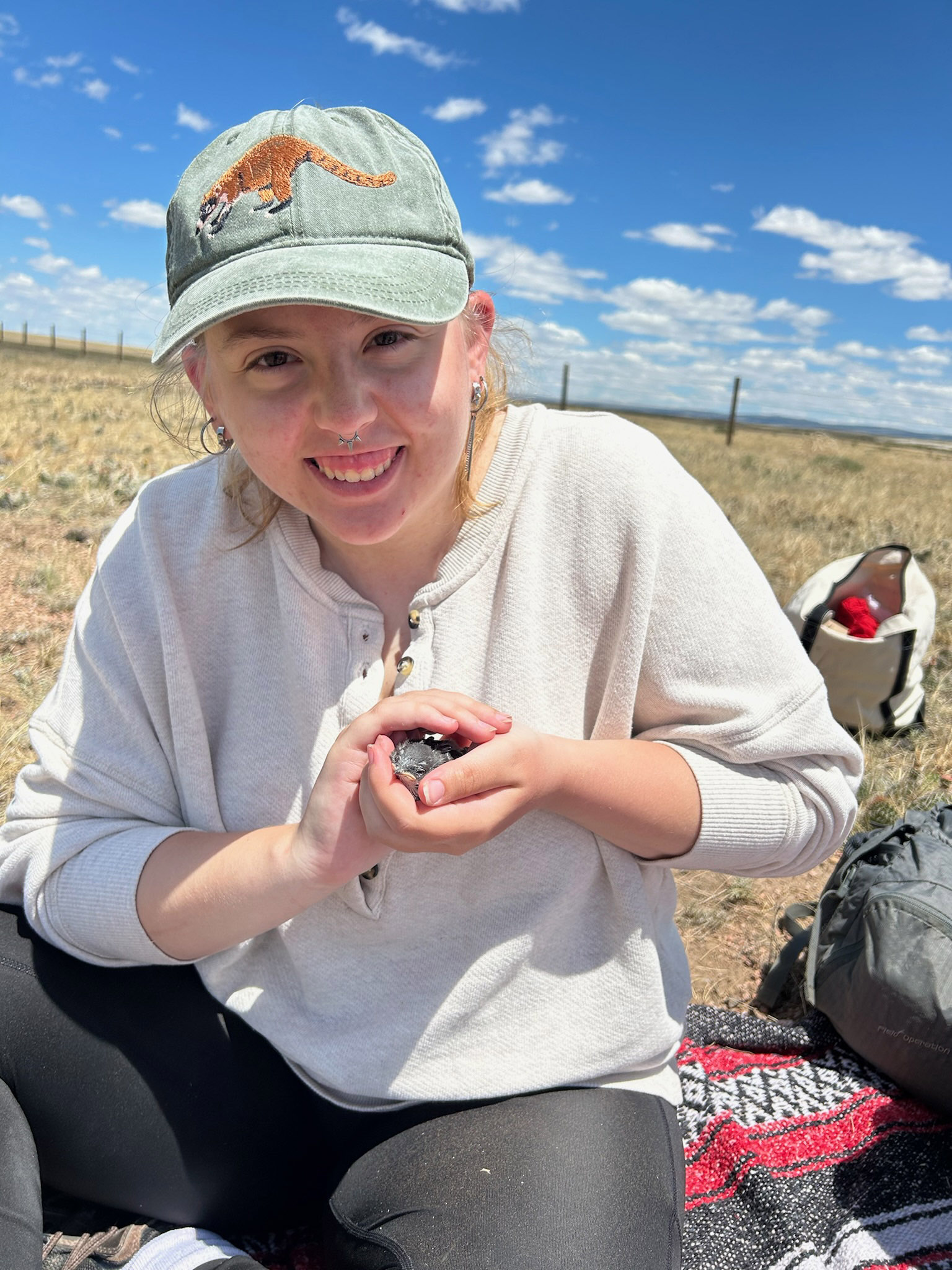 Chloe Flager-Hess cradles a tree swallow.