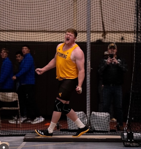 Daniel Reynolds at an indoor track meet wearing University of Wyoming uniform