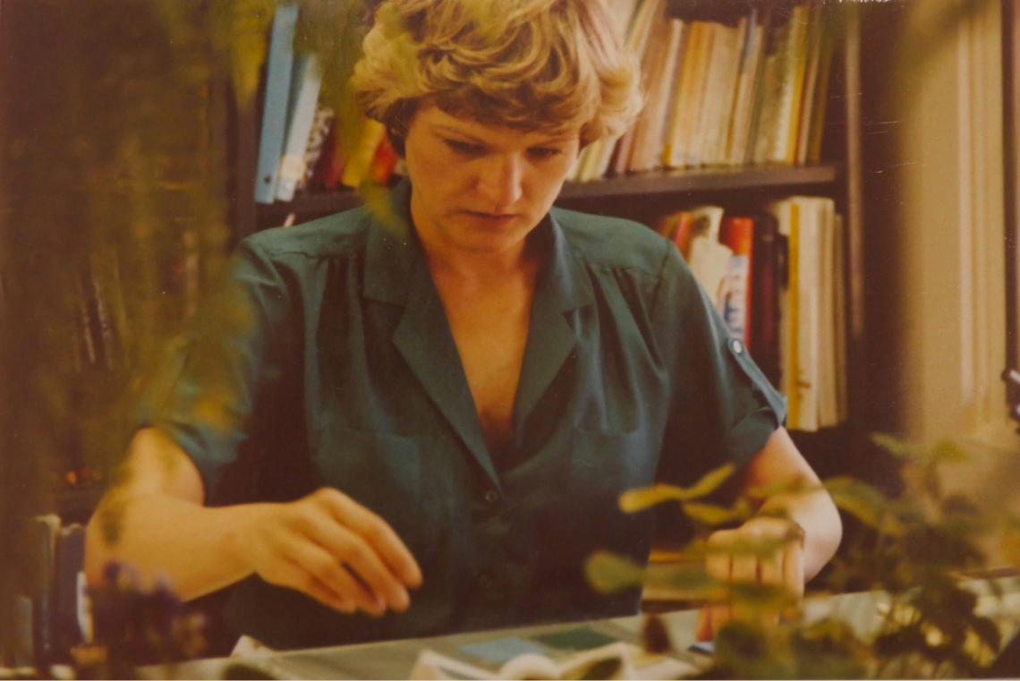 Mary Martin works with plants and materials at a table during an Extension workshop.